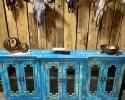 Painted a beautiful blue, this buffet offers lots of space to display your china, silver or prized possessions. Hand Carved out of solid wood. It has six glass paned doors with two shelves.