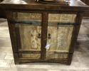 Welcome your guest with this rustic weathered two door cabinet Perfect for an entryway. Constructed from solid wood and rustic iron hardware. Behind the the doors is a shelf to store anything from a purse to extra shoes.
