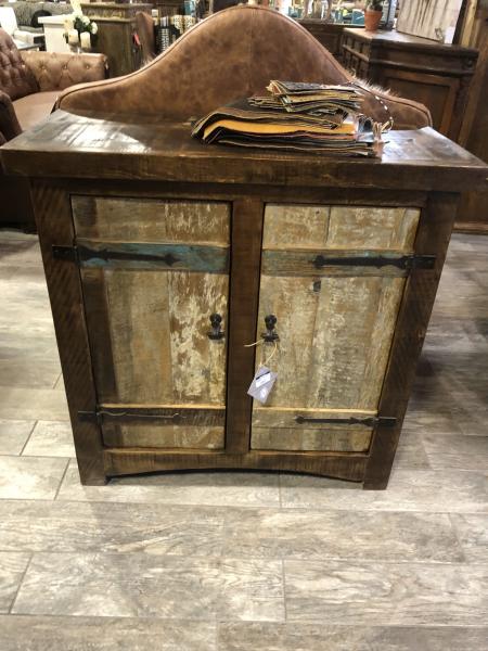 Welcome your guest with this rustic weathered two door cabinet Perfect for an entryway. Constructed from solid wood and rustic iron hardware. Behind the the doors is a shelf to store anything from a purse to extra shoes.