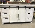 Solid wood handmade TV Stand painted a rustic white and adorned with black iron hardware.

Six drawers and two shelves behind a sliding barn-style door offer plenty of space for games, movies, pictures, or anything else you want close at hand.