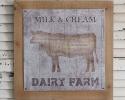 Vintage Dairy Farm Wall Art is printed on metal and sits on a wood frame. It hangs with two triangle ring hangers.
19¾'' sq. x ¼''D